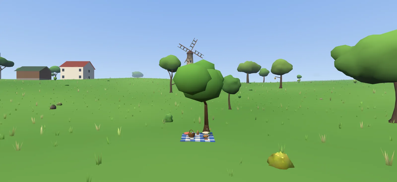 A windmill behind a tree with a picnic blanket in its shade