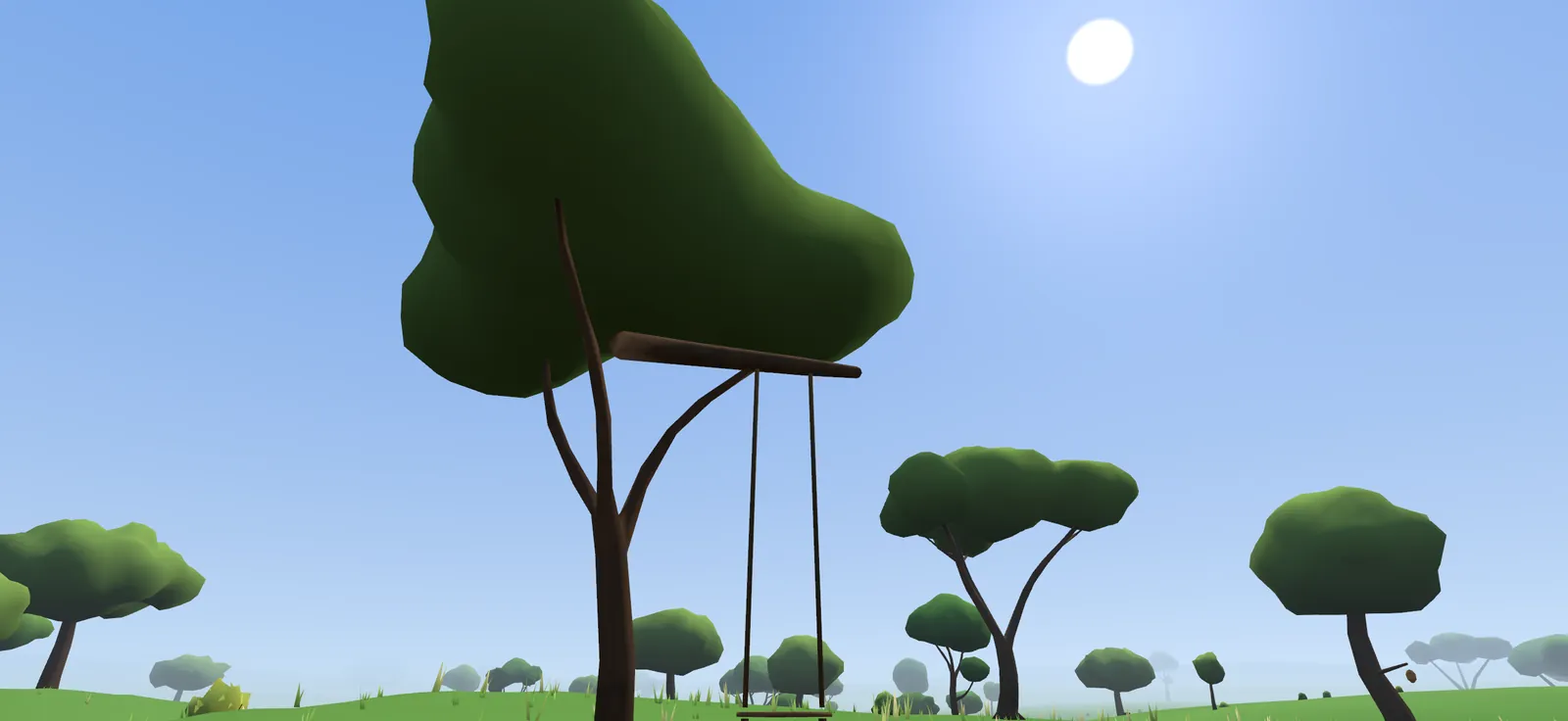 A rope swing hanging from a wide tree
